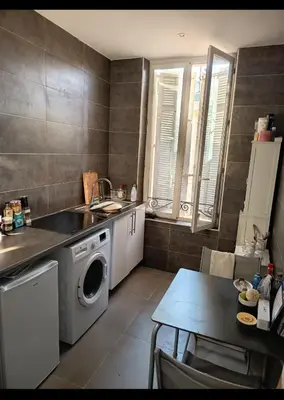 a kitchen with a sink and a washing machine at Apartment Cosy Shared Center of Cannes in Cannes