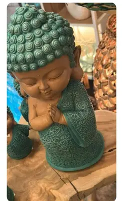a green statue of a mermaid sitting on a table at Apartment Cosy Shared Center of Cannes in Cannes