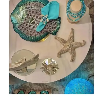 a table with starfish and other items on it at Apartment Cosy Shared Center of Cannes in Cannes