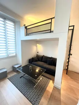 a living room with a couch and a loft bed at Studio Neuf Clim 4p - Cannes in Cannes