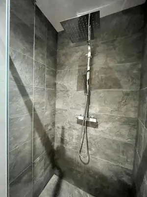 a shower with a hose in a bathroom at Studio Neuf Clim 4p - Cannes in Cannes