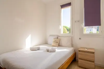 a white bedroom with a bed with towels on it at LE MADRID avec balcon proche Croisette plages et Palais des Festivals in Cannes