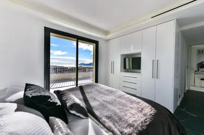 a bedroom with a bed and a large window at L'HORIZON avec somptueuse terrasse vue mer in Cannes