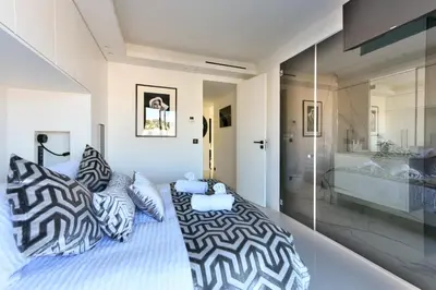 a bedroom with a bed with zebra pillows at L'HORIZON avec somptueuse terrasse vue mer in Cannes