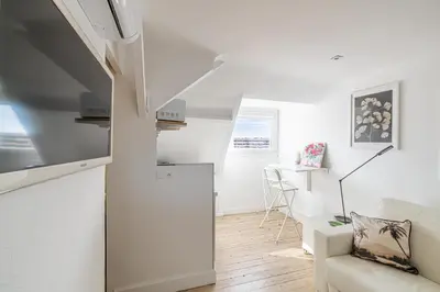 a white living room with a couch and a table at LE VANILLE studio cosy au cœur de la Banane in Cannes