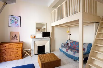 a bedroom with a bunk bed and a fireplace at LE RÉTRO studio avec mezzanine en plein centre in Cannes