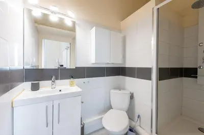 a bathroom with a toilet and a sink and a shower at LE RÉTRO studio avec mezzanine en plein centre in Cannes