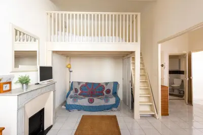 a room with a bunk bed and a desk at LE RÉTRO studio avec mezzanine en plein centre in Cannes