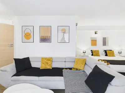 a living room with a white couch and yellow pillows at LE PALME D'OR splendide studio cocon près de la Croisette, du Palais et des plages in Cannes