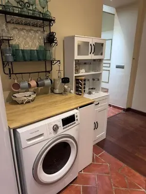 a kitchen with a washing machine in a kitchen at L'AUTHENTIQUE charme rustique et rétro proche Croisette et plages in Cannes
