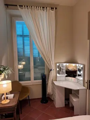 a bedroom with a mirror and a desk and a window at L'AUTHENTIQUE charme rustique et rétro proche Croisette et plages in Cannes