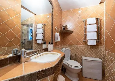 a bathroom with a sink and a toilet and a mirror at L'AUTHENTIQUE charme rustique et rétro proche Croisette et plages in Cannes