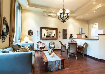 a living room with a blue couch and a table at L'AUTHENTIQUE charme rustique et rétro proche Croisette et plages in Cannes