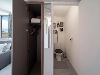 a bathroom with a toilet in a room at Duplex centre de Cannes - terrasse, sunset & pool in Cannes