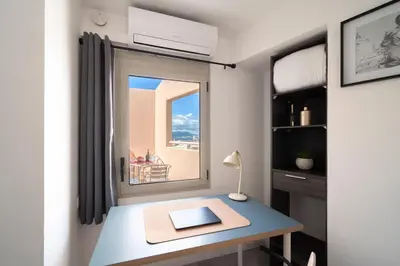 a room with a desk with a window and a desk at Duplex centre de Cannes - terrasse, sunset & pool in Cannes