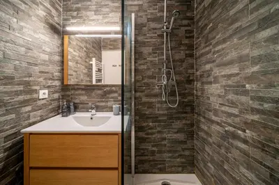 a bathroom with a sink and a shower at Duplex centre de Cannes - terrasse, sunset & pool in Cannes