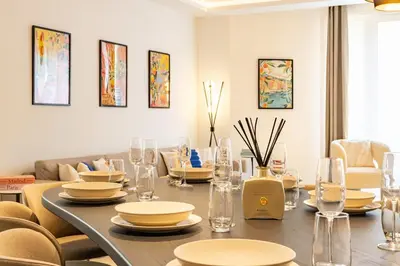a dining room with a table and chairs at Elégant et moderne T4 à 100M de La Croisette in Cannes