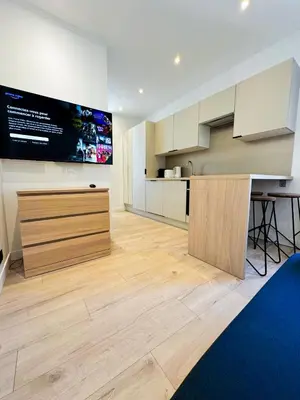 a kitchen with a large screen on the wall at Suite Palmiers d'Or Cannes in Cannes