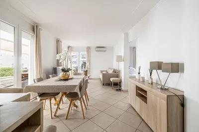 a kitchen and dining room with a table and chairs at 78 LERINS - Bel appartement 2 chambres sur la Croisette in Cannes