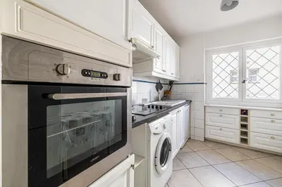 a kitchen with a stove and a dishwasher at 78 LERINS - Bel appartement 2 chambres sur la Croisette in Cannes