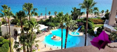 an aerial view of a resort with a pool and the ocean at Theo'z apartments in Cannes