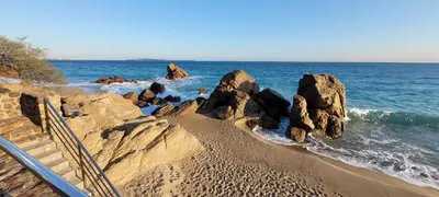 a beach with some rocks in the water at Theo'z apartments in Cannes