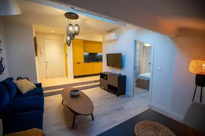 a living room with a couch and a table at Stylish Central Cannes Apartment in Cannes