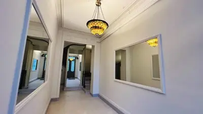 a hallway with mirrors and a chandelier in a house at Stylish Central Cannes Apartment in Cannes