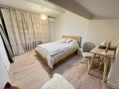 a bedroom with a bed and a desk and a window at Stylish Central Cannes Apartment in Cannes