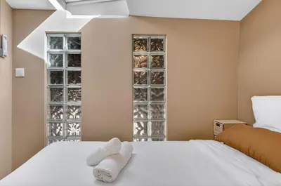 a bedroom with a white bed with towels on it at 2 Bedrooms sea view in Le Suquet in Cannes