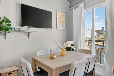 a living room with a table and chairs at 2 Bedrooms sea view in Le Suquet in Cannes