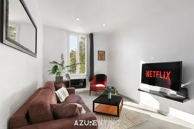 a kitchen with green cabinets and a table and chairs at Azurenting - Bastide Oliva - 1 chambre - Balcon in Cannes