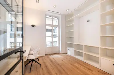 a room with white shelves and a desk and a window at Le 121 - LOFT design Rue d'Antibes in Cannes