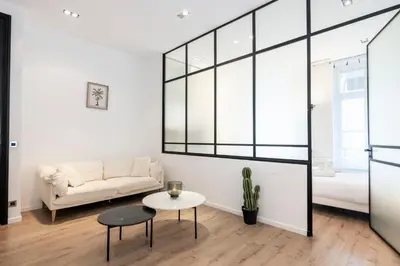 a living room with a couch and a table at Le 121 - LOFT design Rue d'Antibes in Cannes