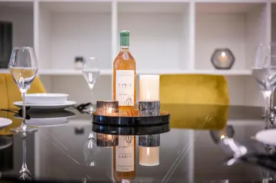 a bottle of wine sitting on a table with glasses at Le 121 - LOFT design Rue d'Antibes in Cannes