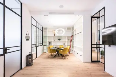 a dining room with a table and yellow chairs at Le 121 - LOFT design Rue d'Antibes in Cannes