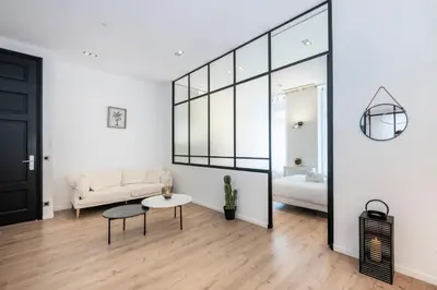 a living room with a couch and a table at Le 121 - LOFT design Rue d'Antibes in Cannes