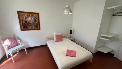 a small room with a bed and a chair at Cannes Center, minutes walk from the Palais des festivals, Beaches, La Croisette and Rue d'Antibes in Cannes