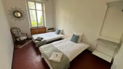 a room with two beds and a window and a mirror at Cannes Center, minutes walk from the Palais des festivals, Beaches, La Croisette and Rue d'Antibes in Cannes