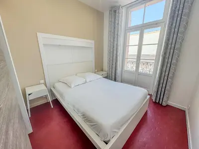 a bedroom with a white bed and a window at RED DOOR Forville Market View in Cannes