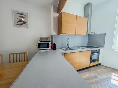 a small kitchen with a sink and a microwave at WOOD Forville Suquet View in Cannes