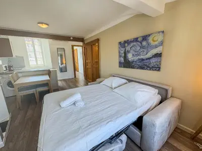 a bedroom with a bed and a table in a room at WOOD Forville Suquet View in Cannes
