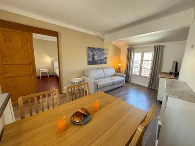a living room with a table and a couch at WOOD Forville Suquet View in Cannes
