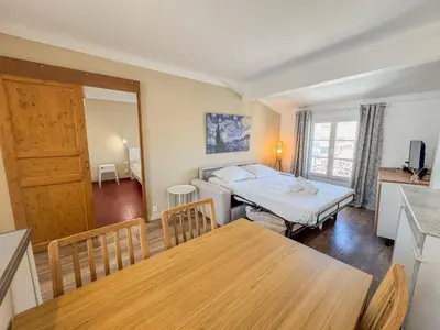 a living room with a bed and a dining table at WOOD Forville Suquet View in Cannes