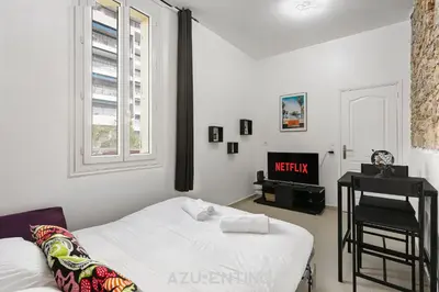 a small kitchen with an arch over a stove at Azurenting - Bastide Alba - Studio - Terrasse in Cannes