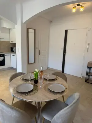 a dining room table with chairs and a dining room at Magnifique T2 avec grande terrasse in Le Cannet