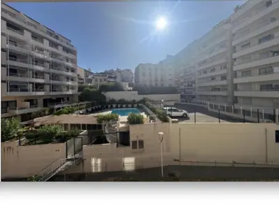 a view of a city with buildings and a pool at La Palme studio in Cannes