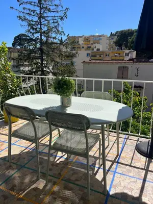a table and chairs sitting on a balcony at 4 bedroom house Le Cannet in Le Cannet