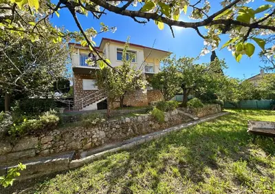 a house with a stone wall and a yard at 4 bedroom house Le Cannet in Le Cannet