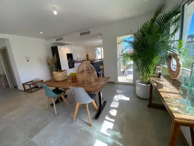 a living room with a wooden table and chairs at 4 bedroom house Le Cannet in Le Cannet